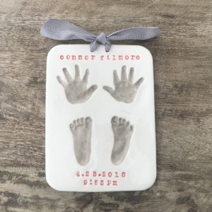 hand and footprints in clay